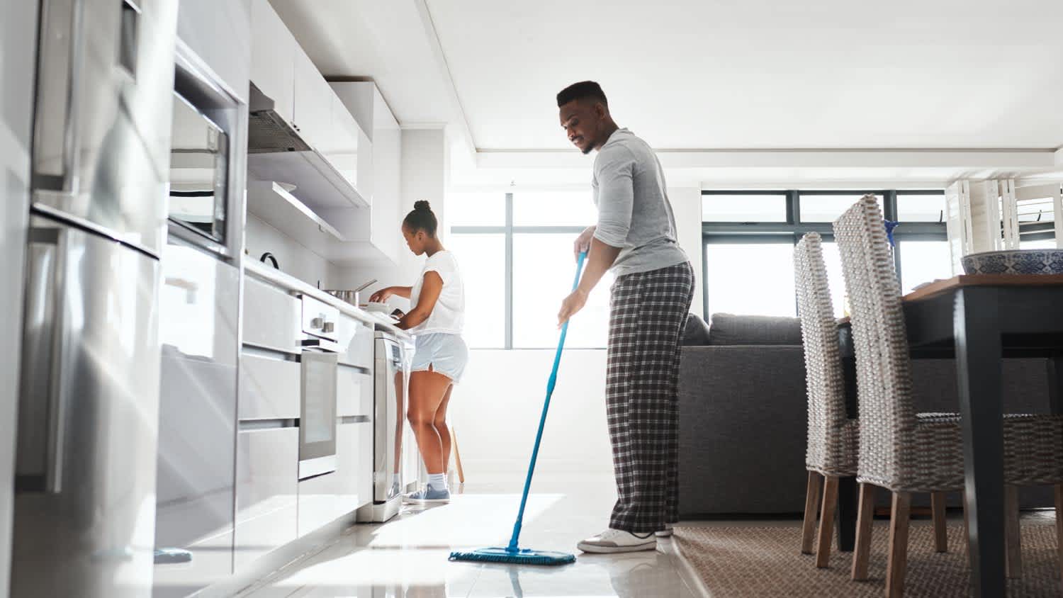 A couple cleaning the kitchen at home