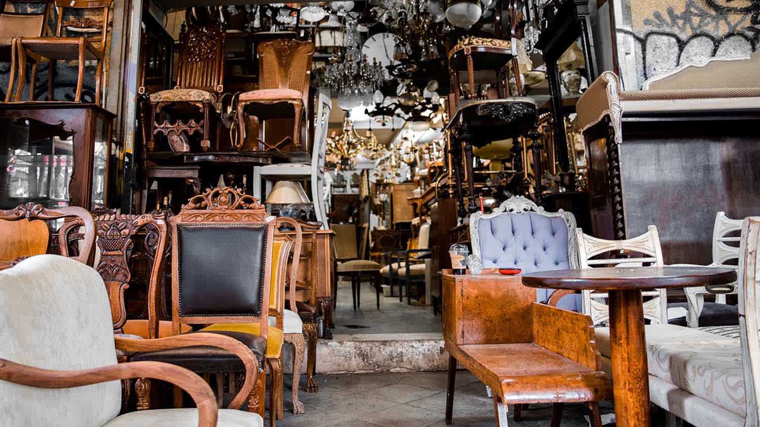 wooden chairs and tables in thrift store