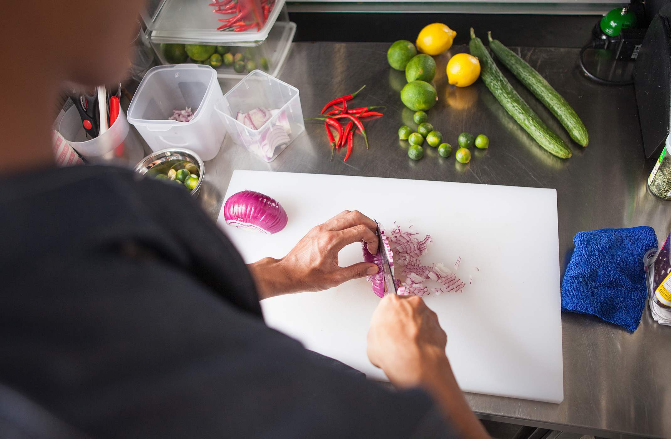 Top view of a man chopping an onion