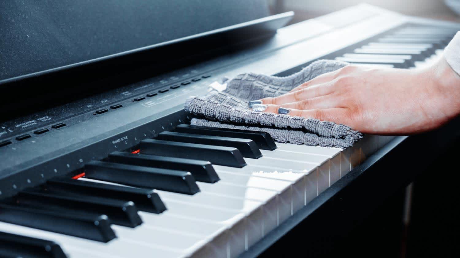 A woman cleaning a piano
