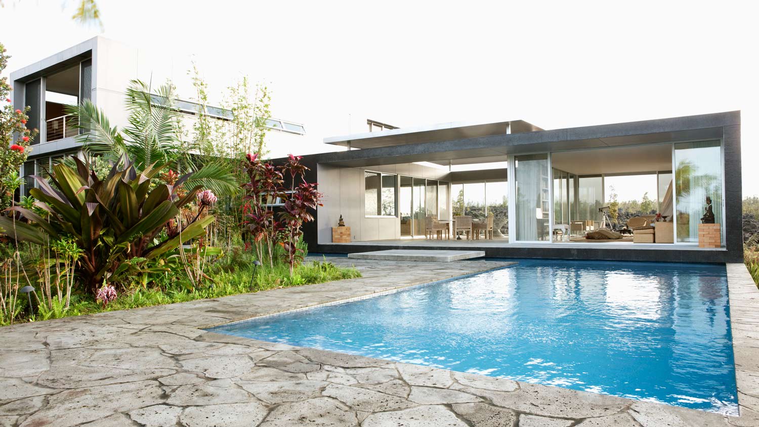 Natural stone patio with a modern house in the background