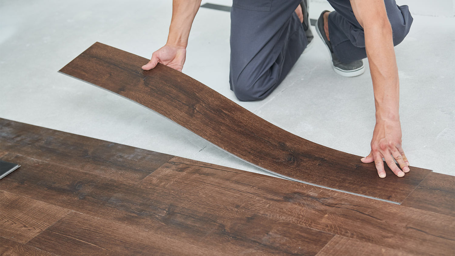 Man installing wood flooring