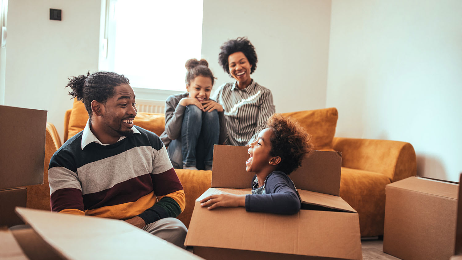 A family packs moving boxes