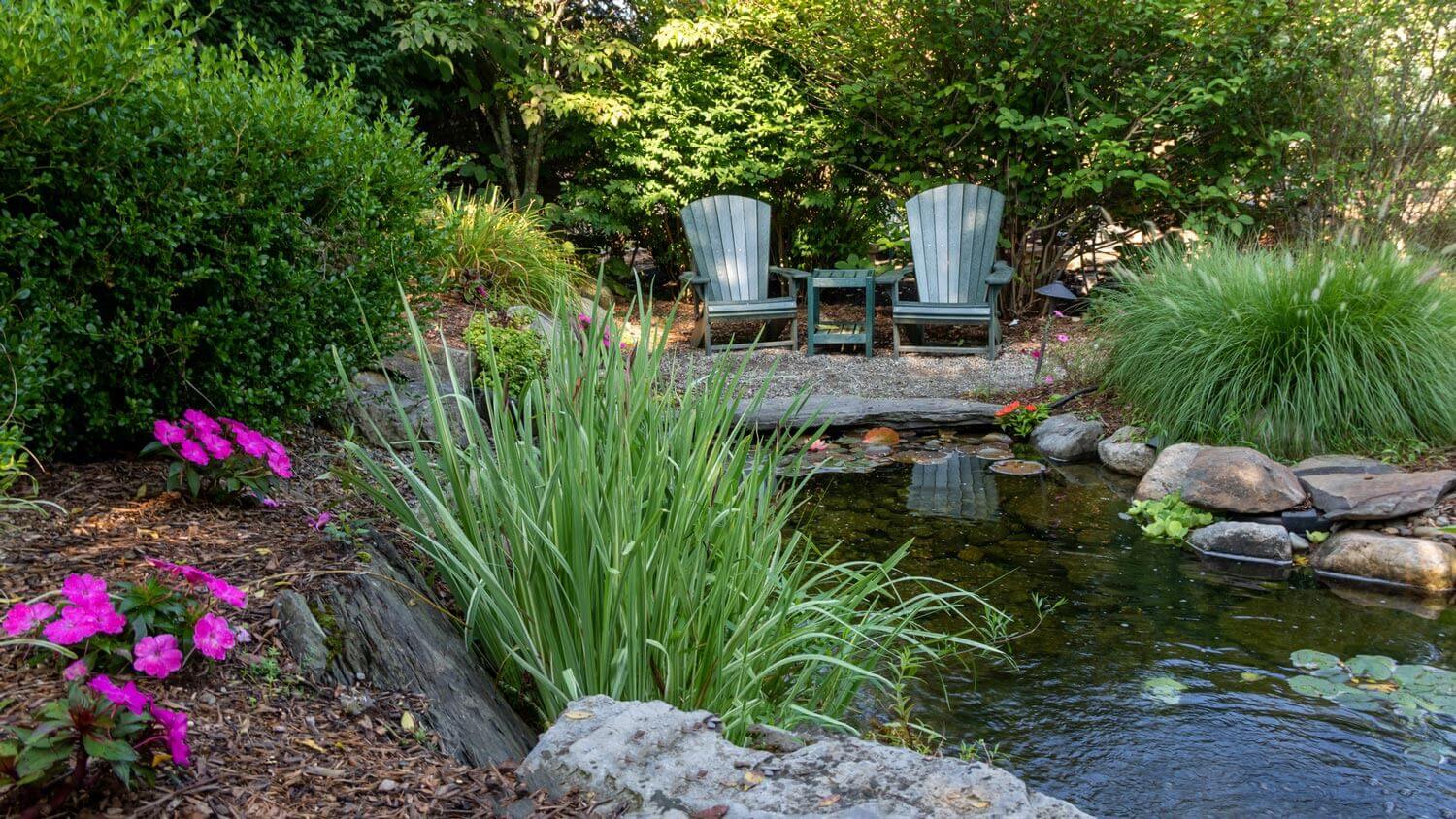 Landscape architecture in a lush garden with a pond