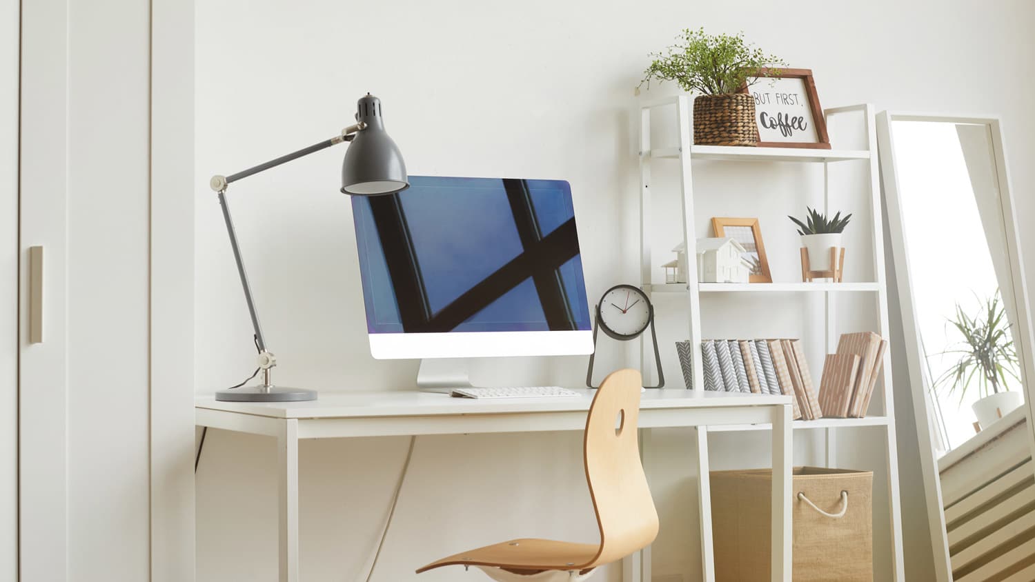 A minimalistic home office workspace with wooden chair