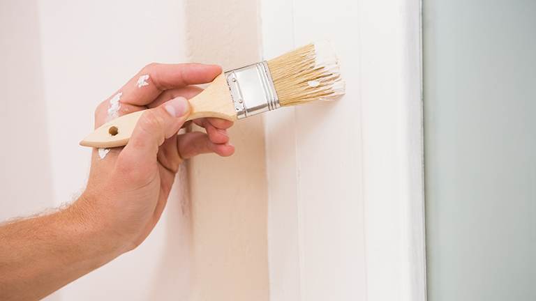 Painting trim white next to a blue wall