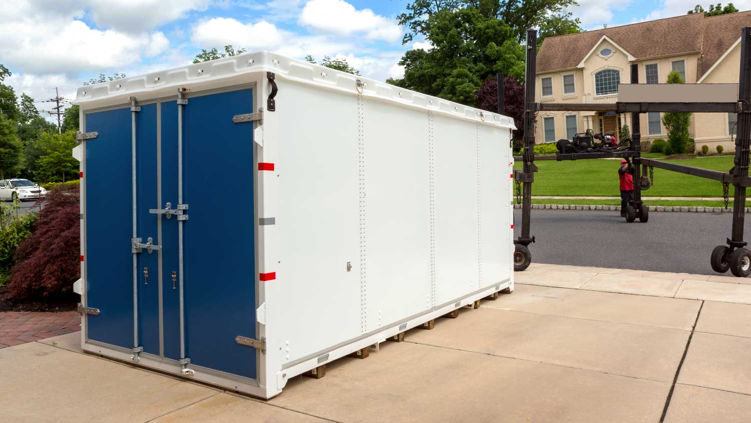 A storage container sits in a driveway