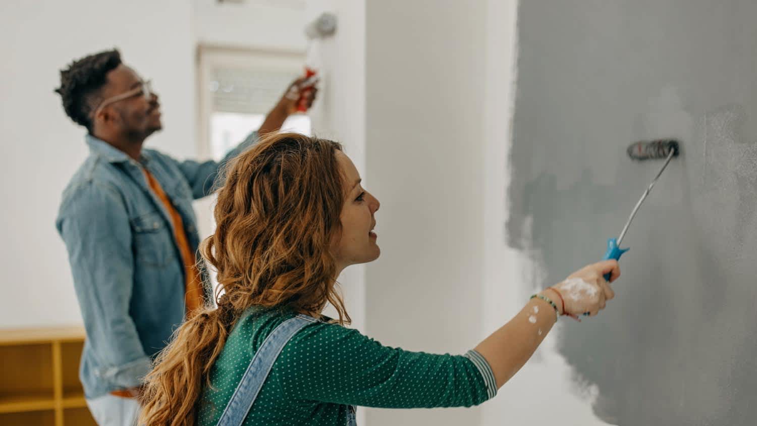 Young couple painting walls