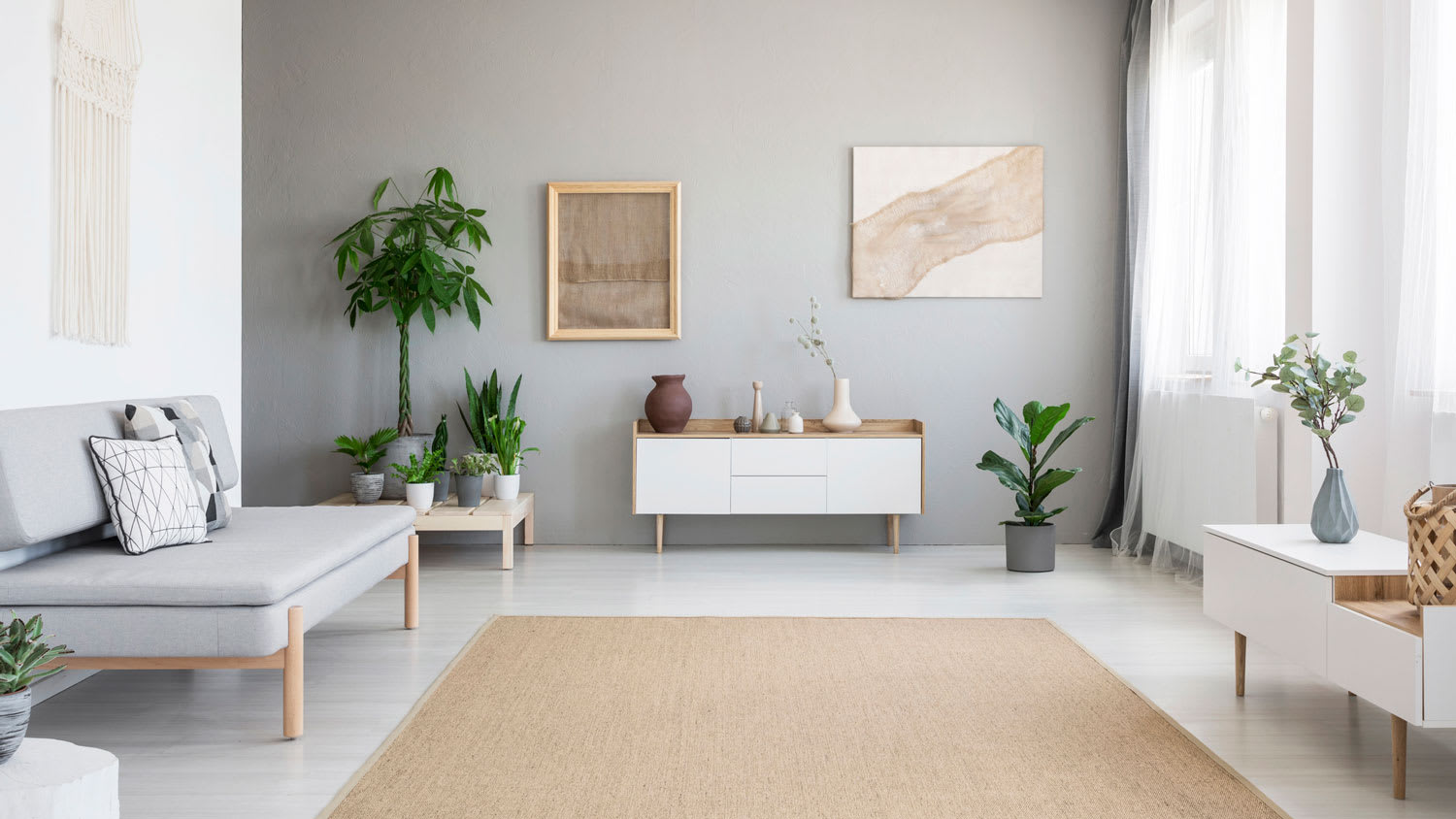 A bright living room with a minimalistic gray sofa