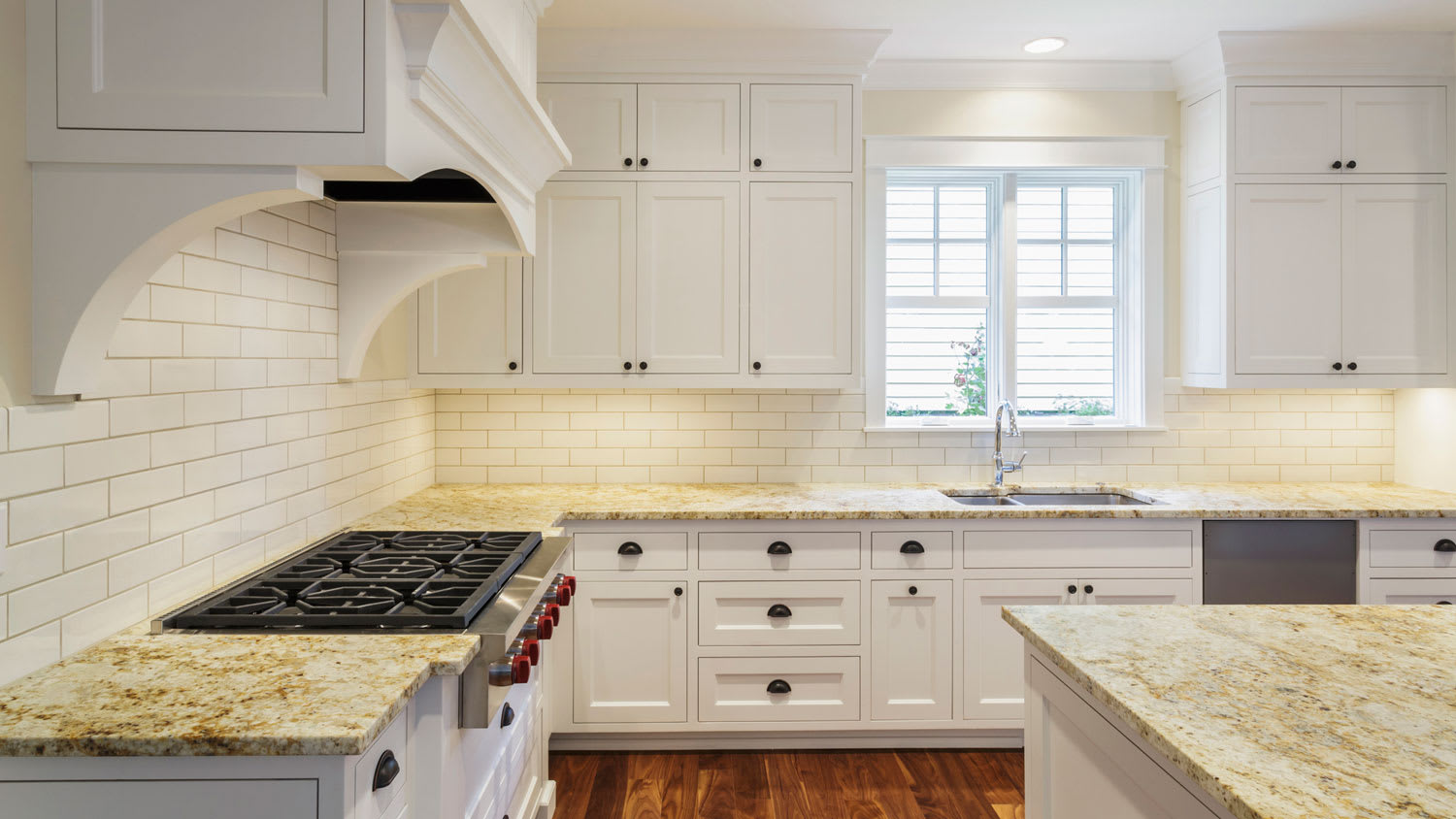 A spacious kitchen with white stacked cabinets