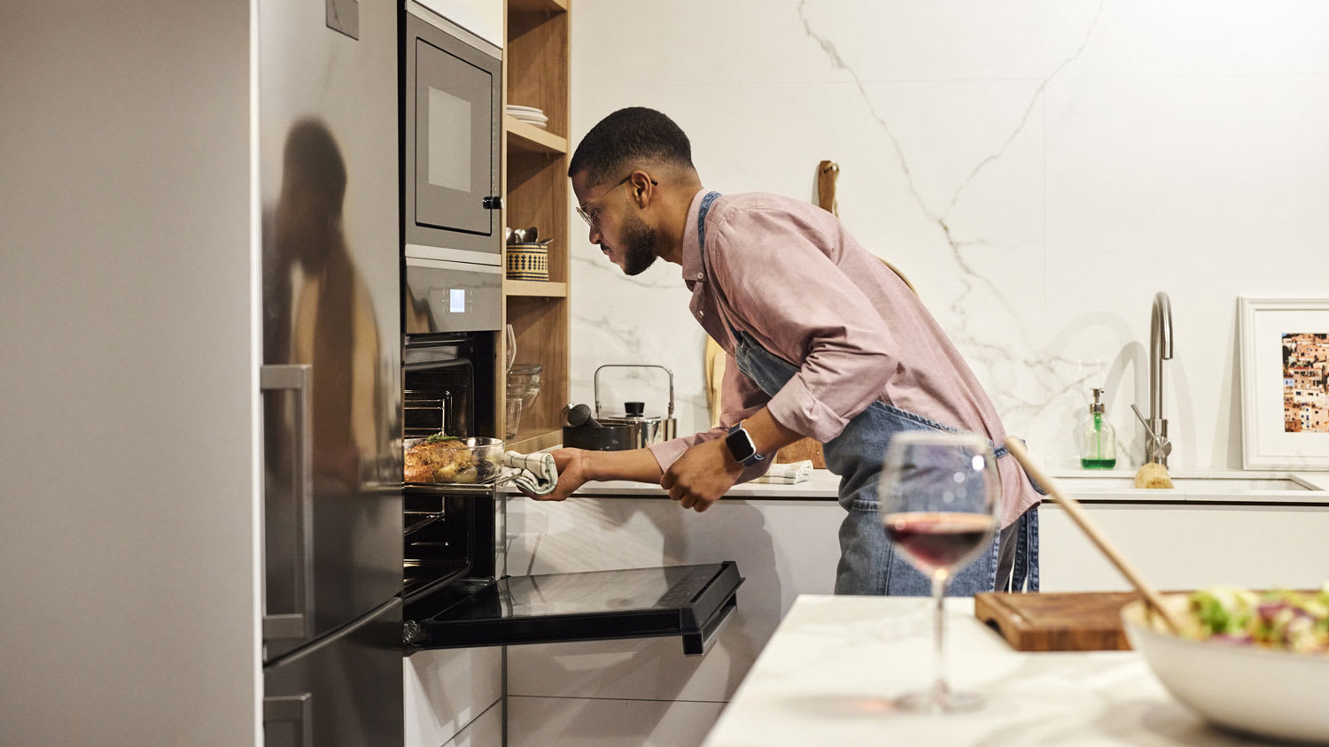 Man removing baked food from the oven