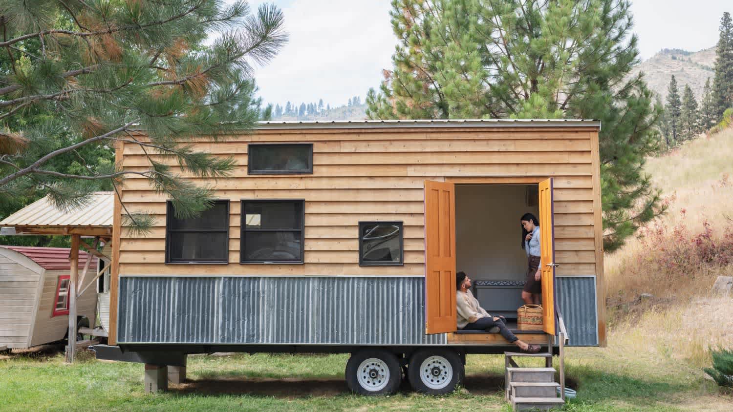 A couple talking in doorway of their tiny house