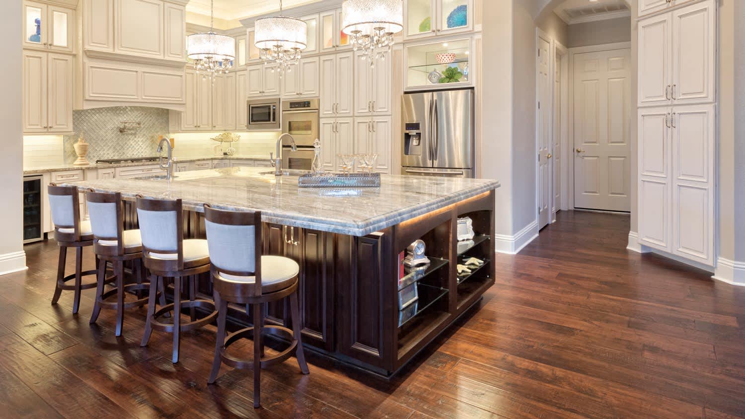 A kitchen with a custom kitchen island and stacked cabinets