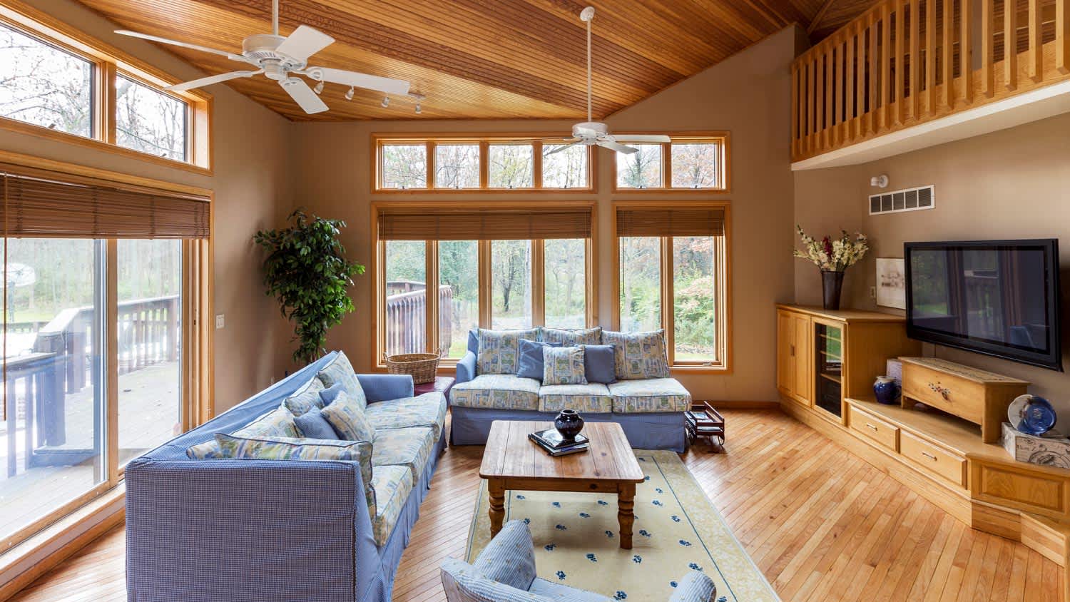 A hardwood floor and ceilings in living room