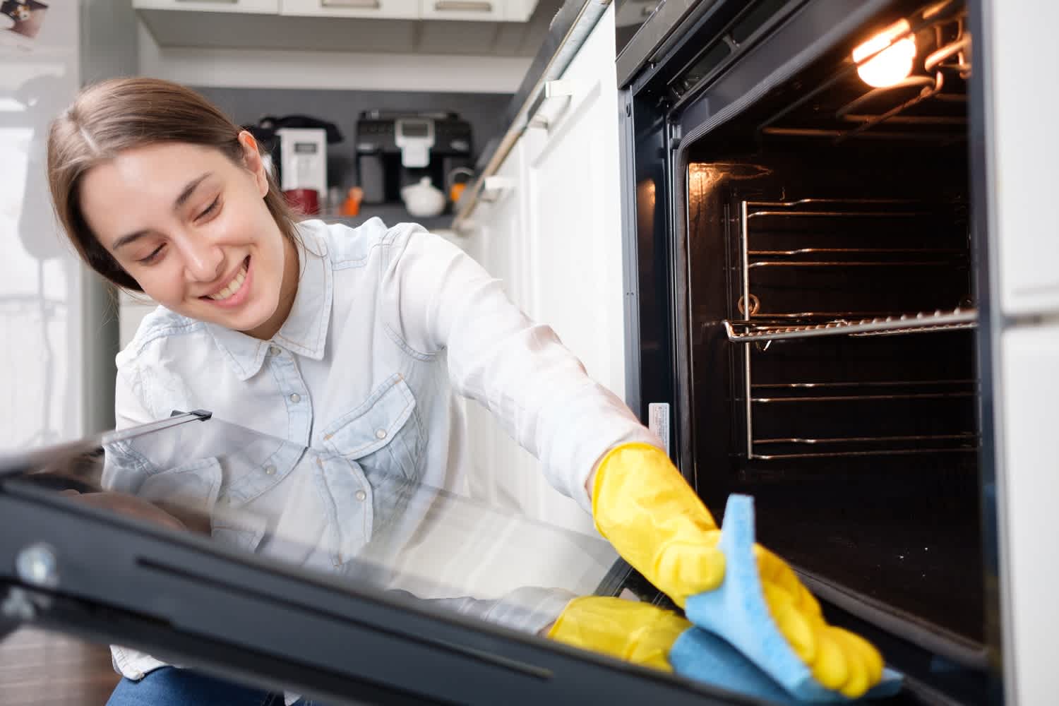 woman cleaning oven