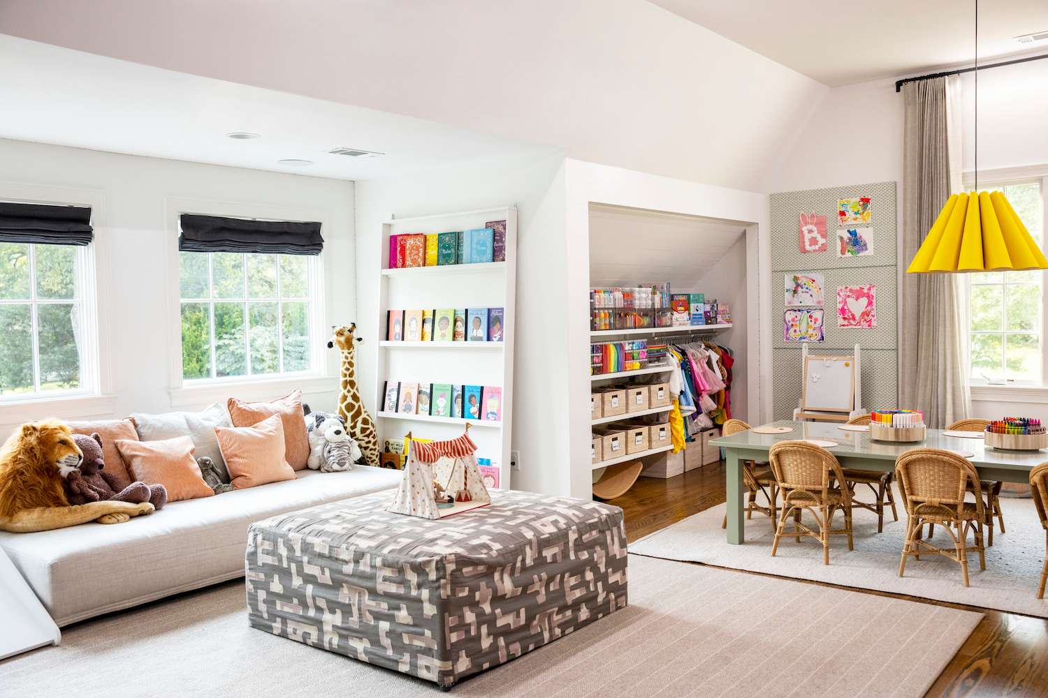 Bright sunny playroom with yellow pendant light and organized book shelves