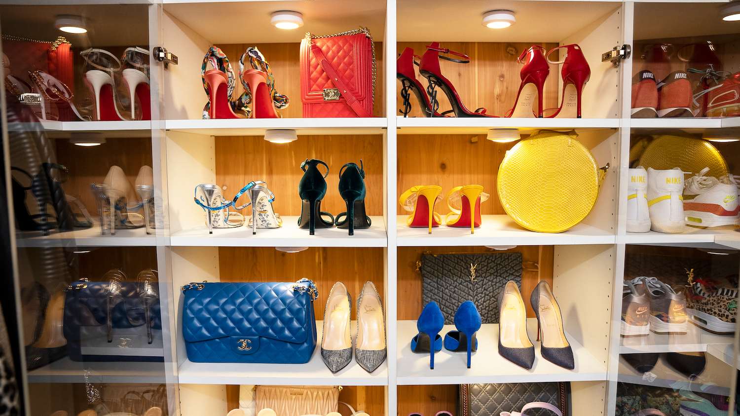 Shoes and bags organized on closet shelves with lighting
