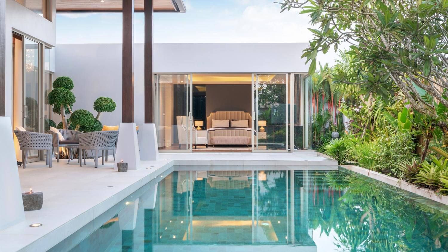 A backyard pool with a lush garden