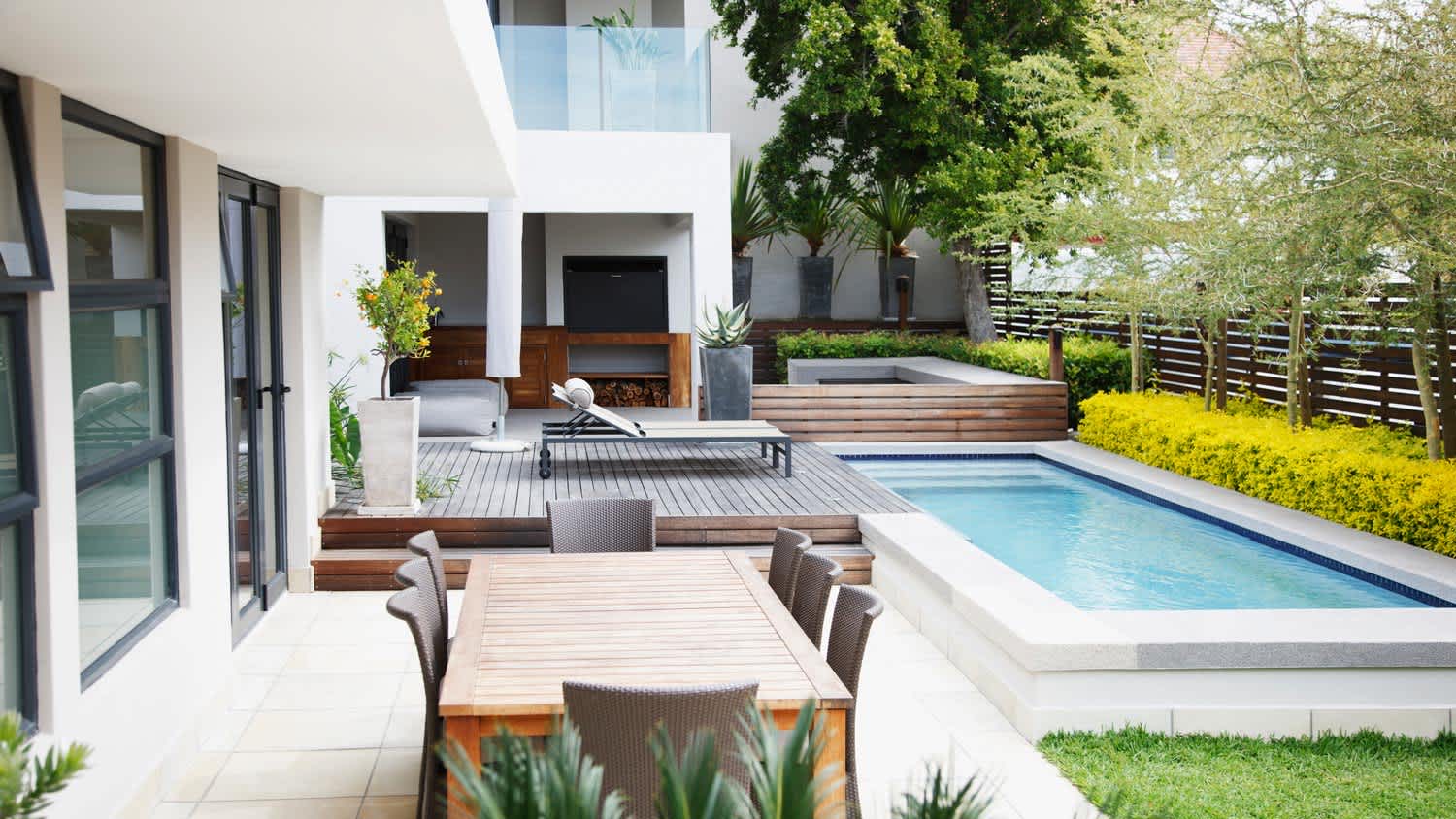 A modern patio next to the swimming pool