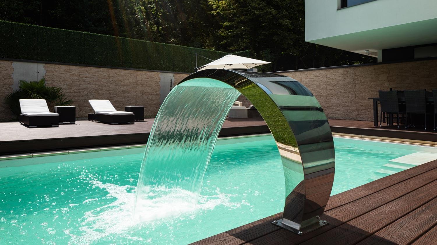A contemporary water fountain in a house’s pool