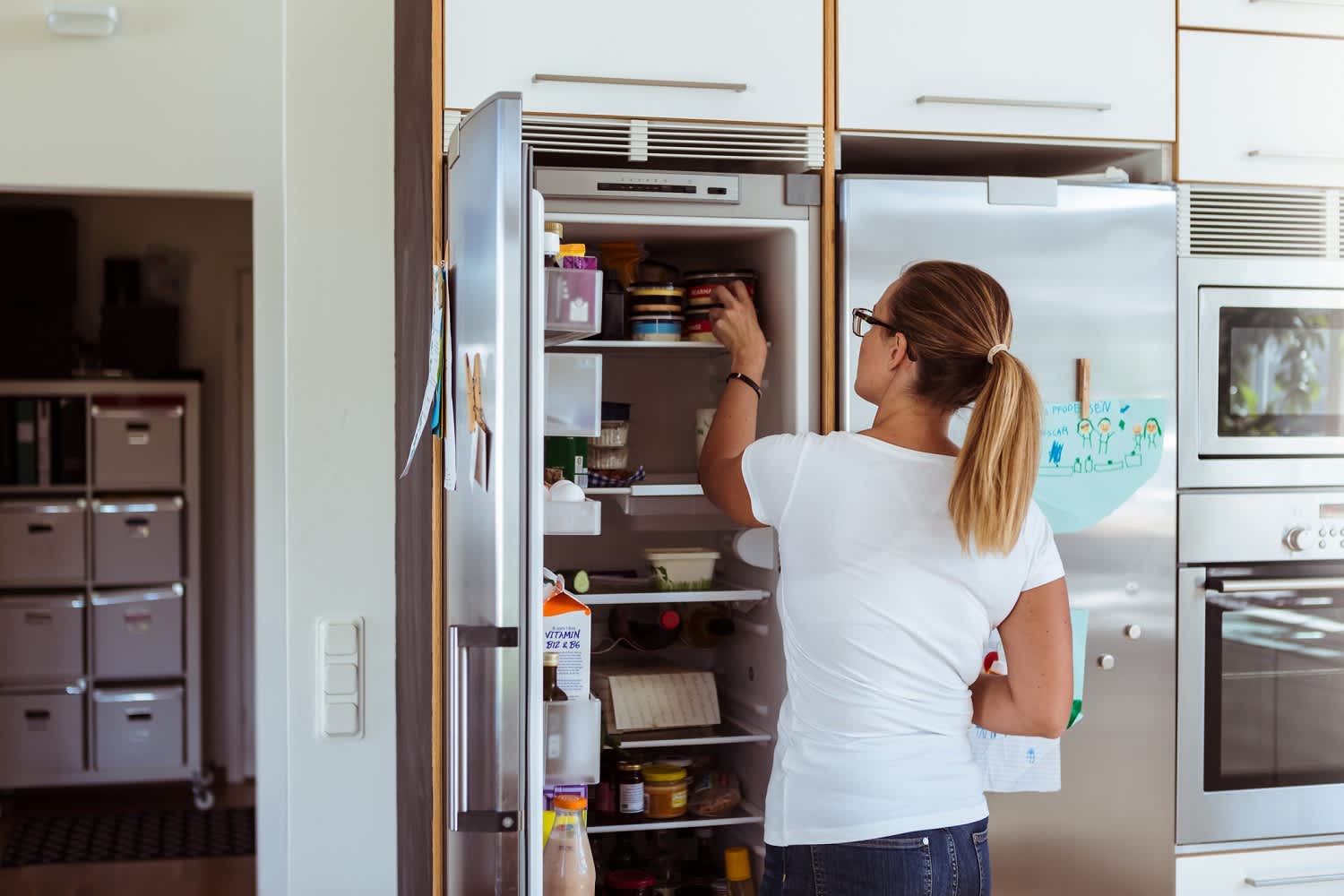 woman looking in fridge