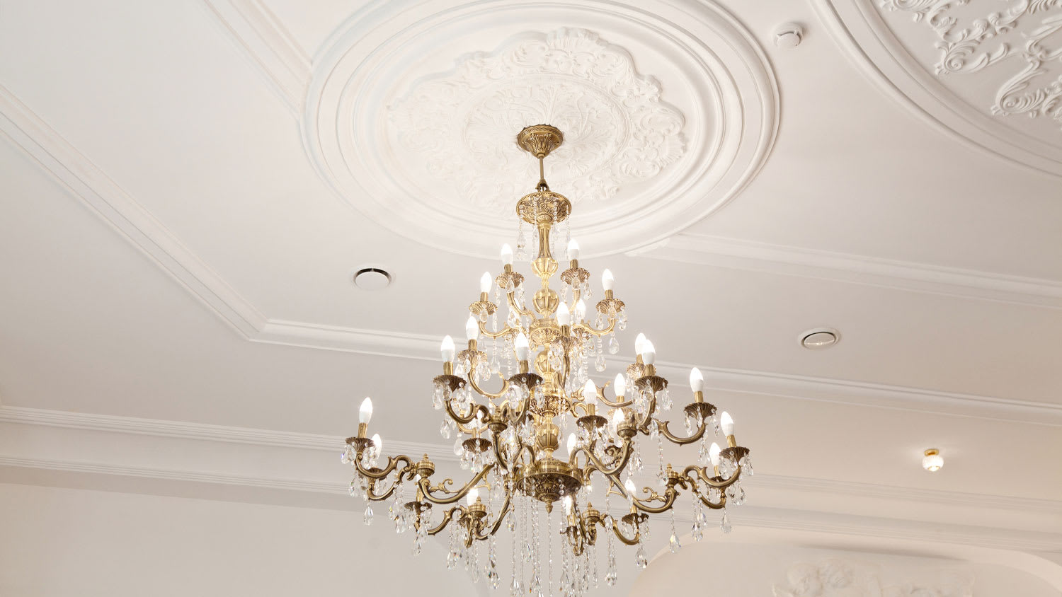 Classic chandelier framed by a ceiling medallion