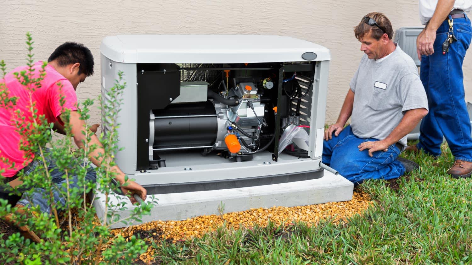 Men installing an whole house emergency generator