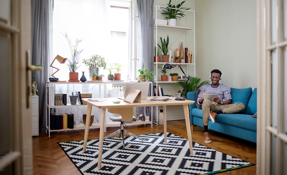 Person sitting on sofa in a small apartment room