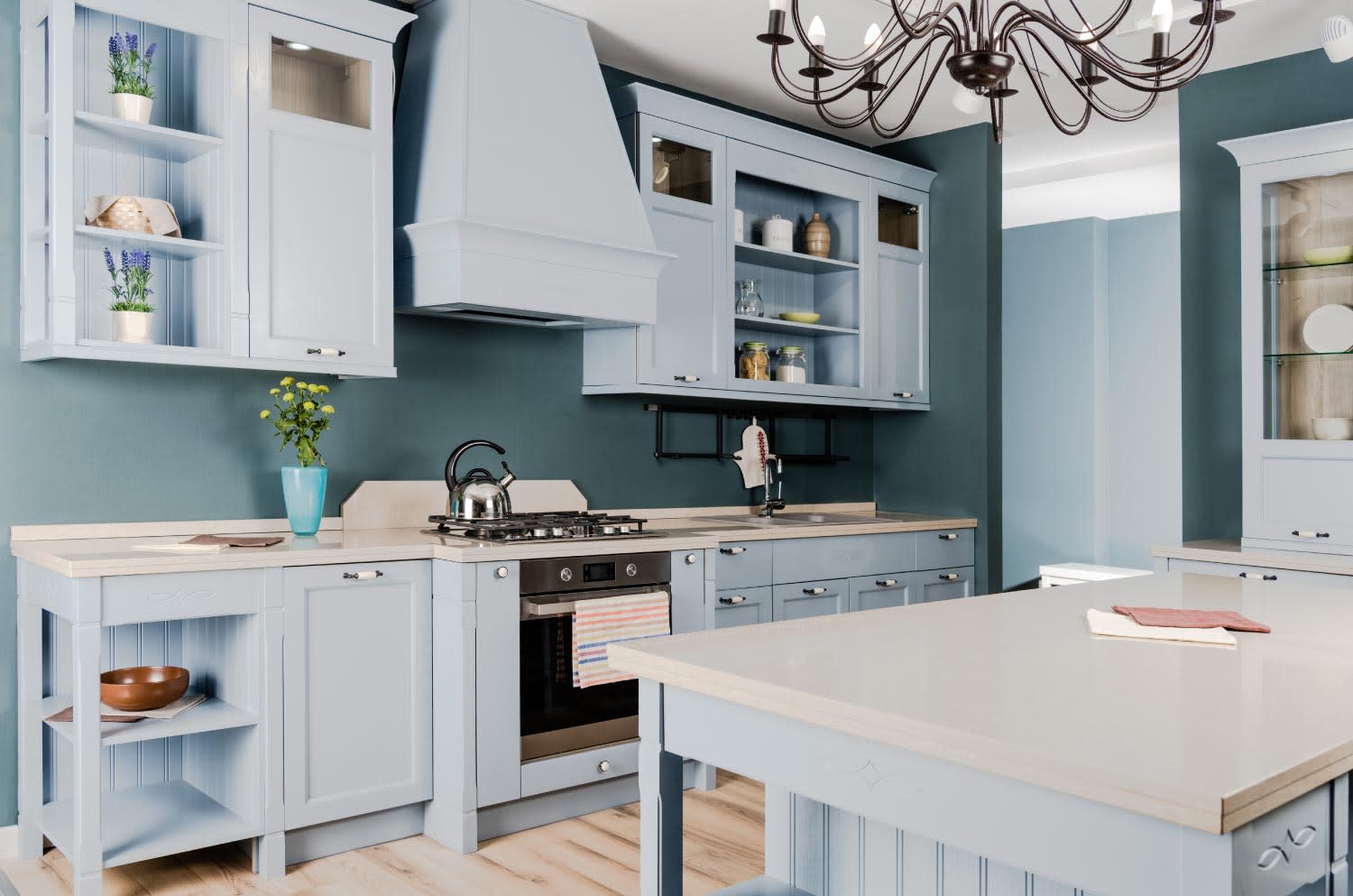 Modern kitchen with light blue cabinets and dark blue walls