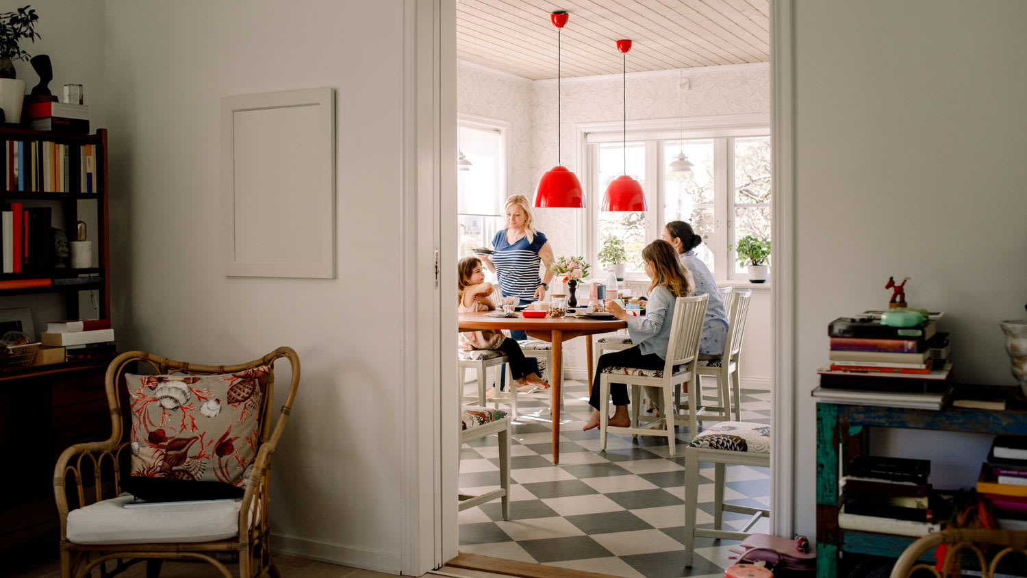 A mother having breakfast with her daughters in bright kitchen