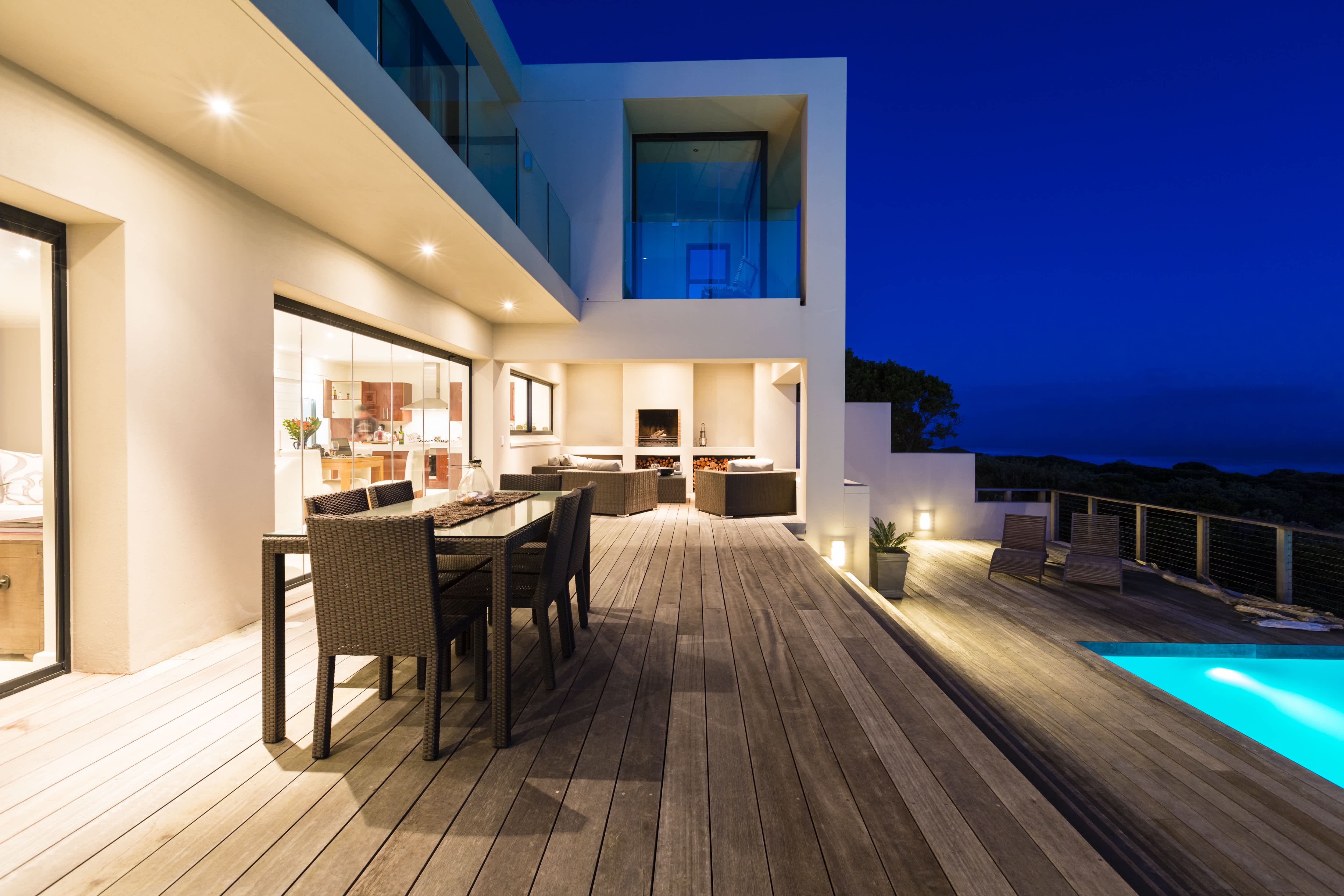 Outdoor living space at night with recessed lighting