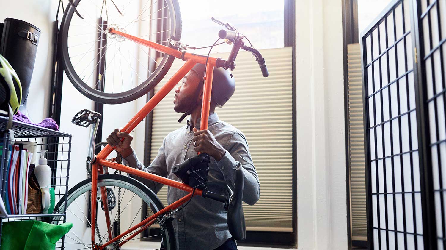 Man hanging bike on wall