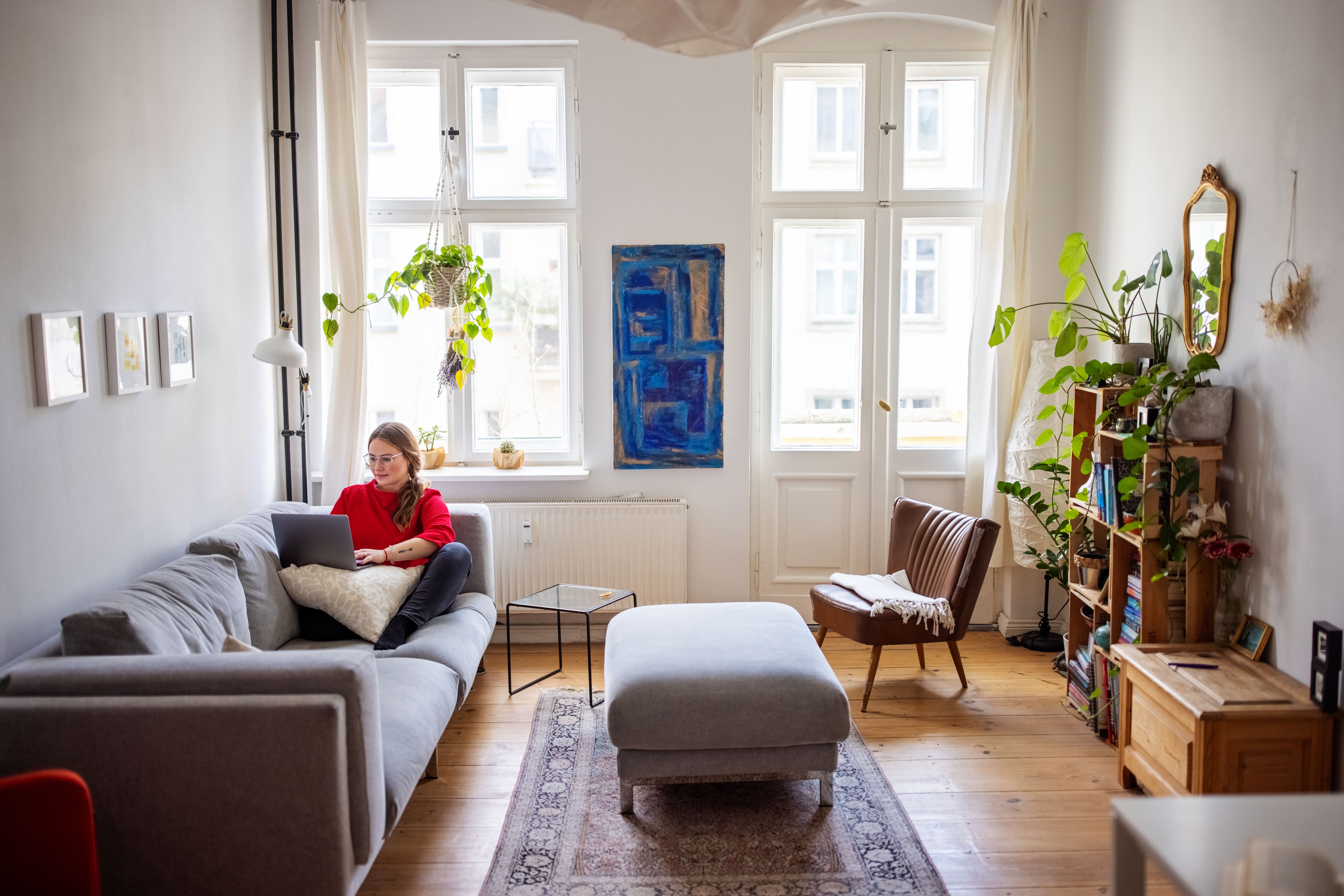 Woman working from home on the couch in her living room