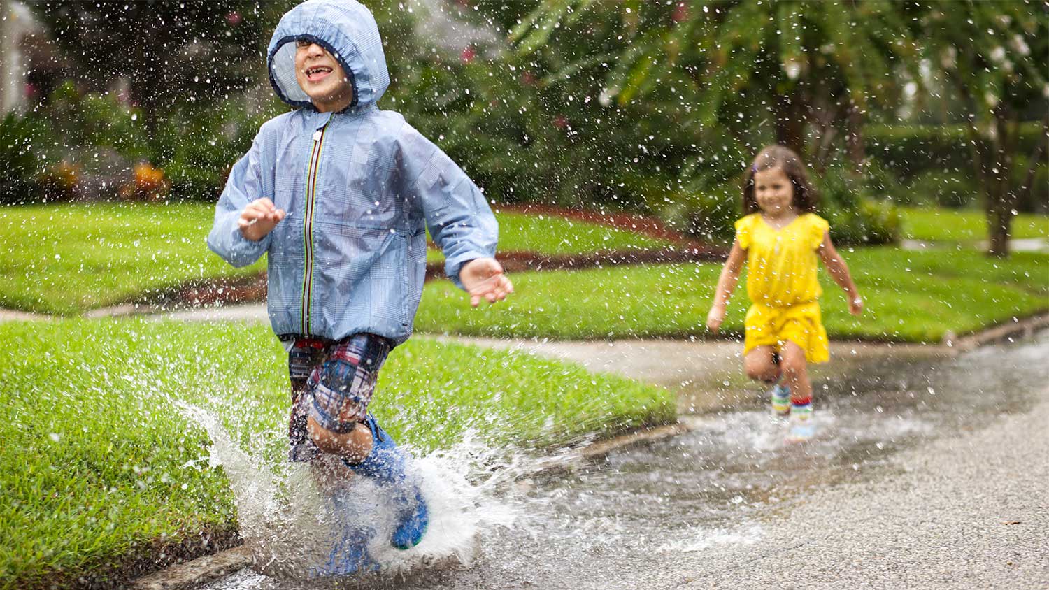 Children splash in the rain
