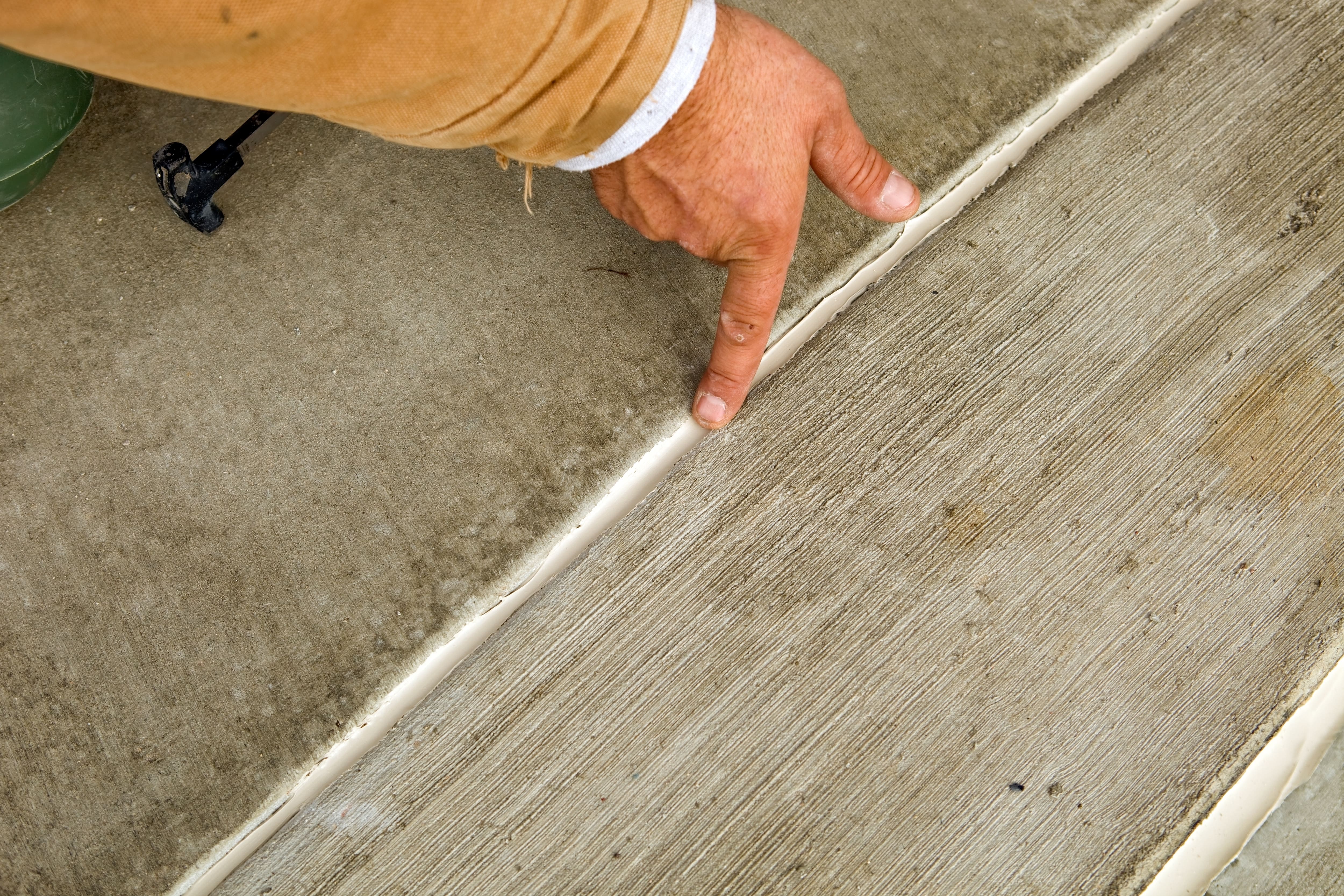 A man smoothing out caulk with his finger