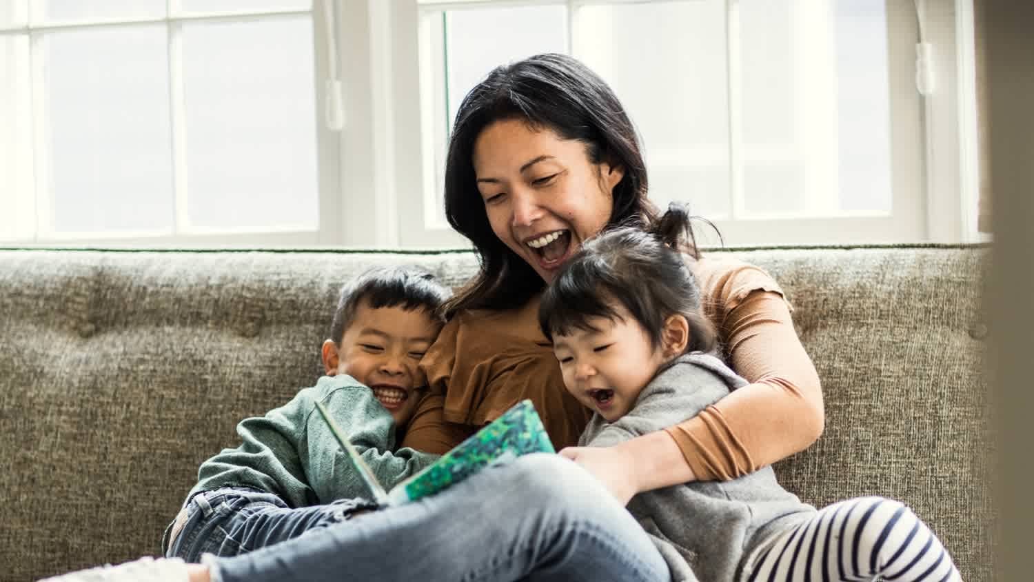 Mother and kids reading a book