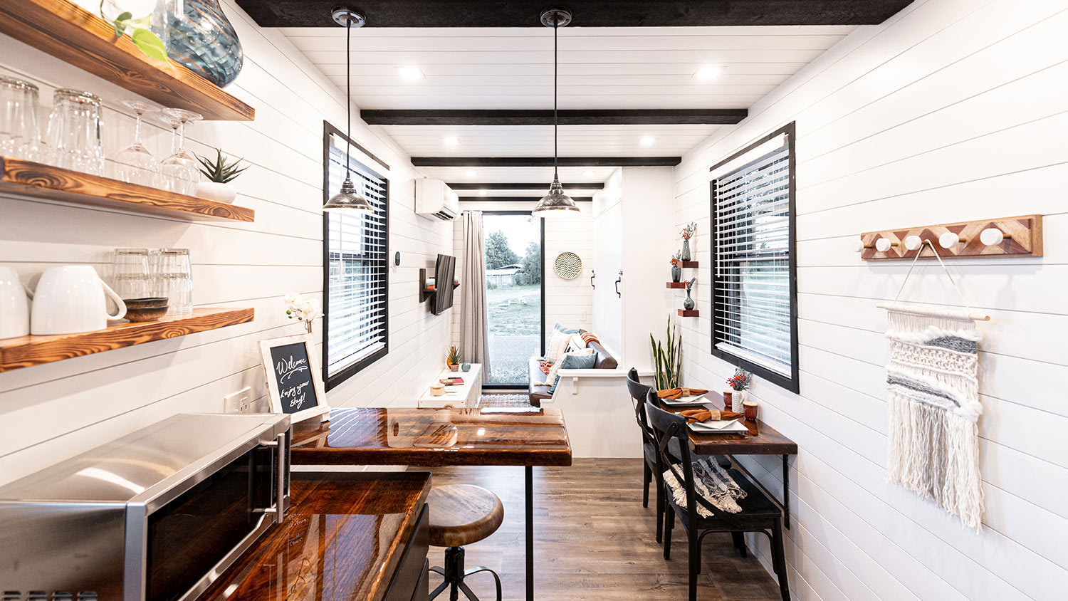 long tiny home interior kitchen and living area