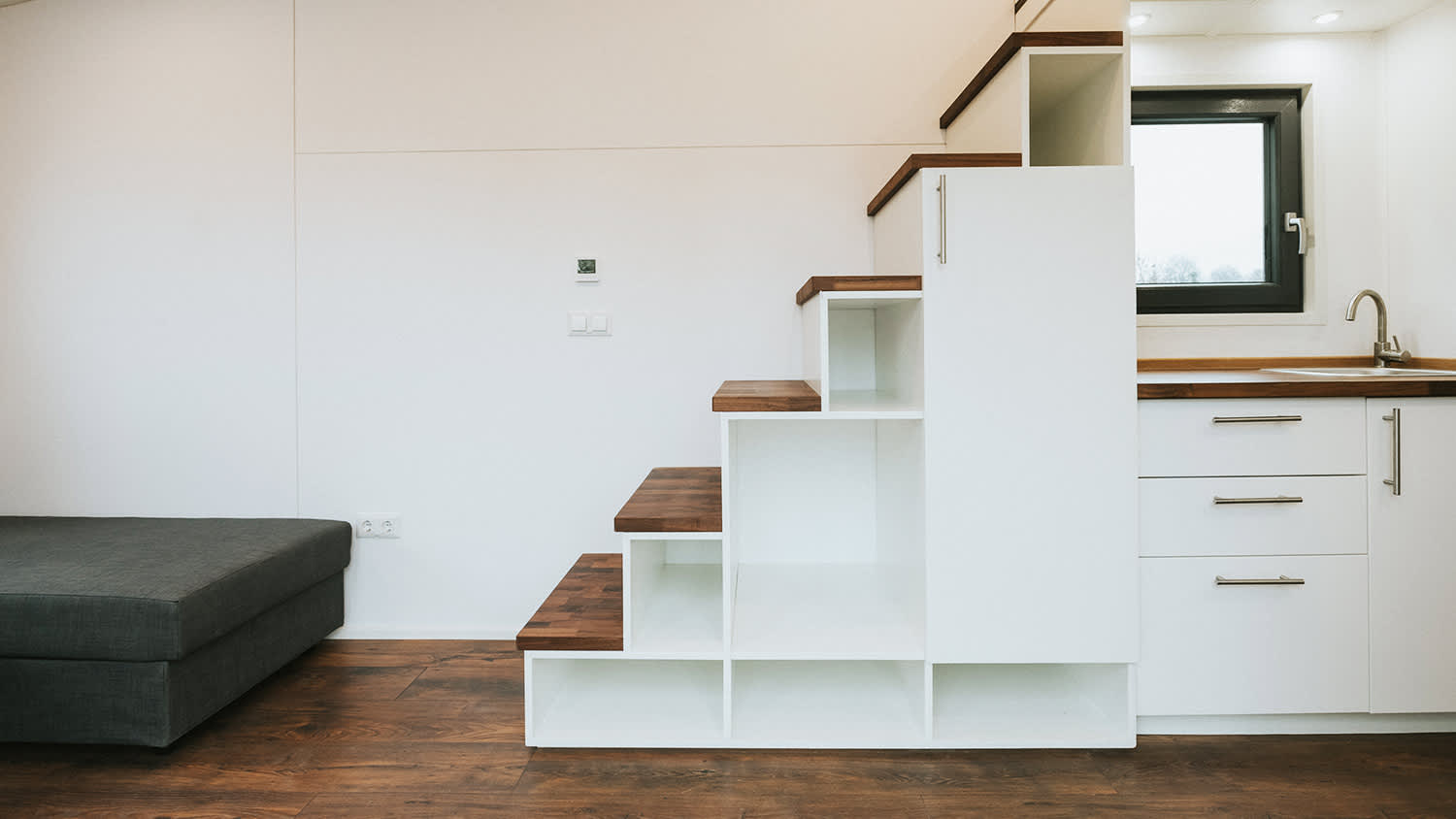 interior of tiny house with under stair storage
