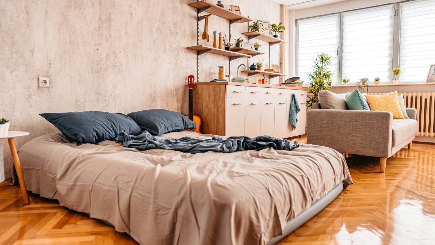 studio apartment with messy bed