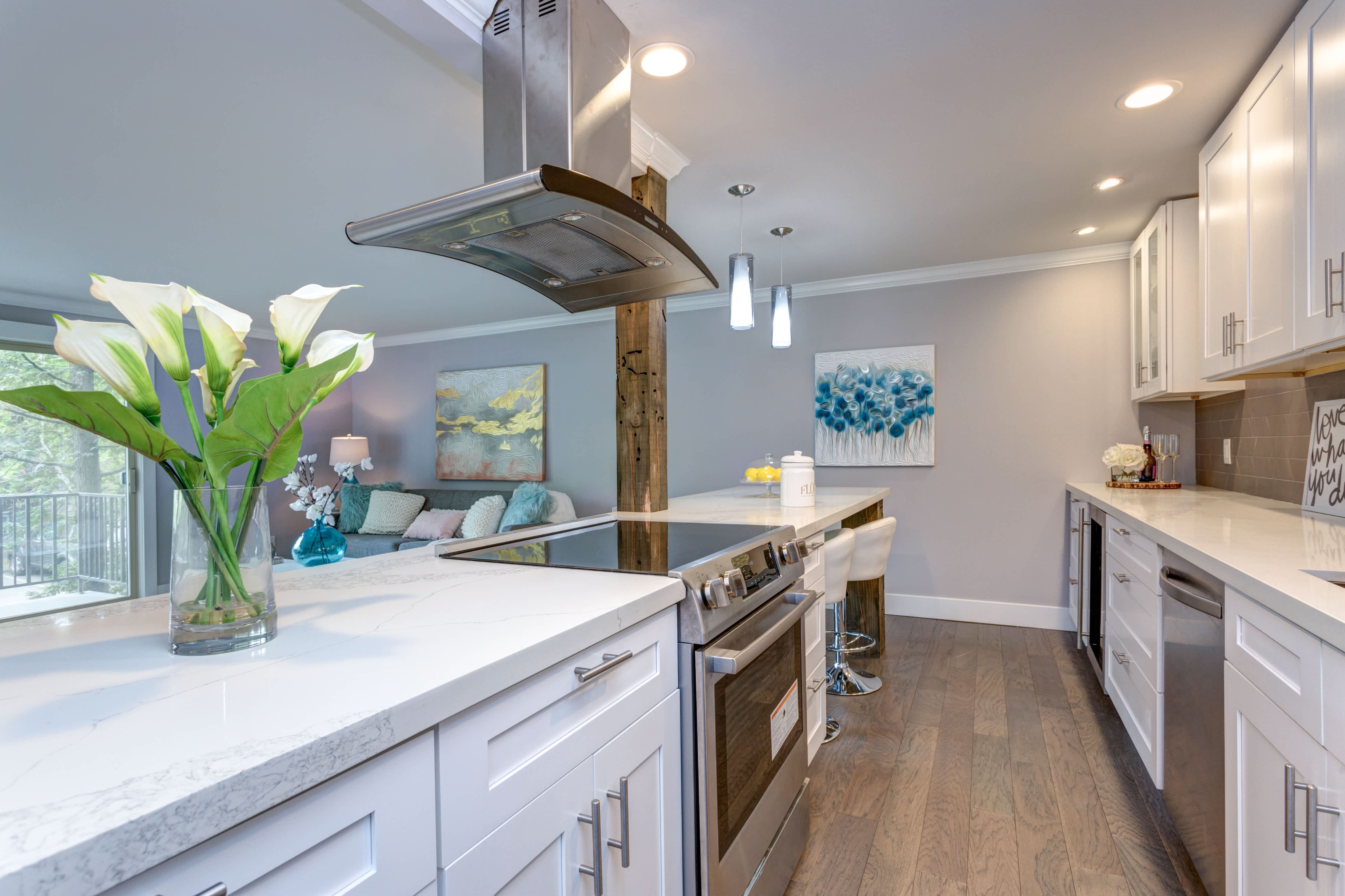 A long and narrow galley kitchen with a half wall