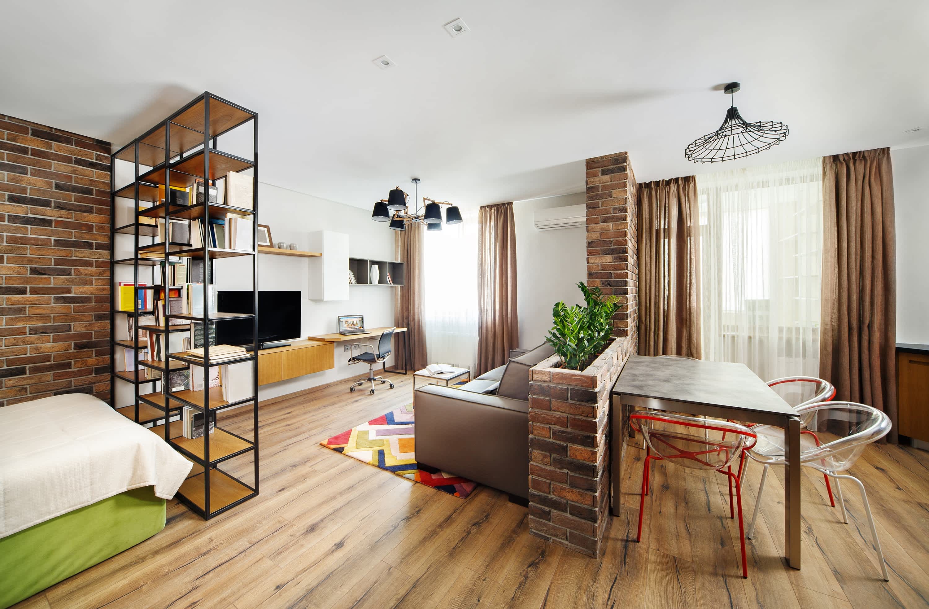 Brick pony wall in studio apartment