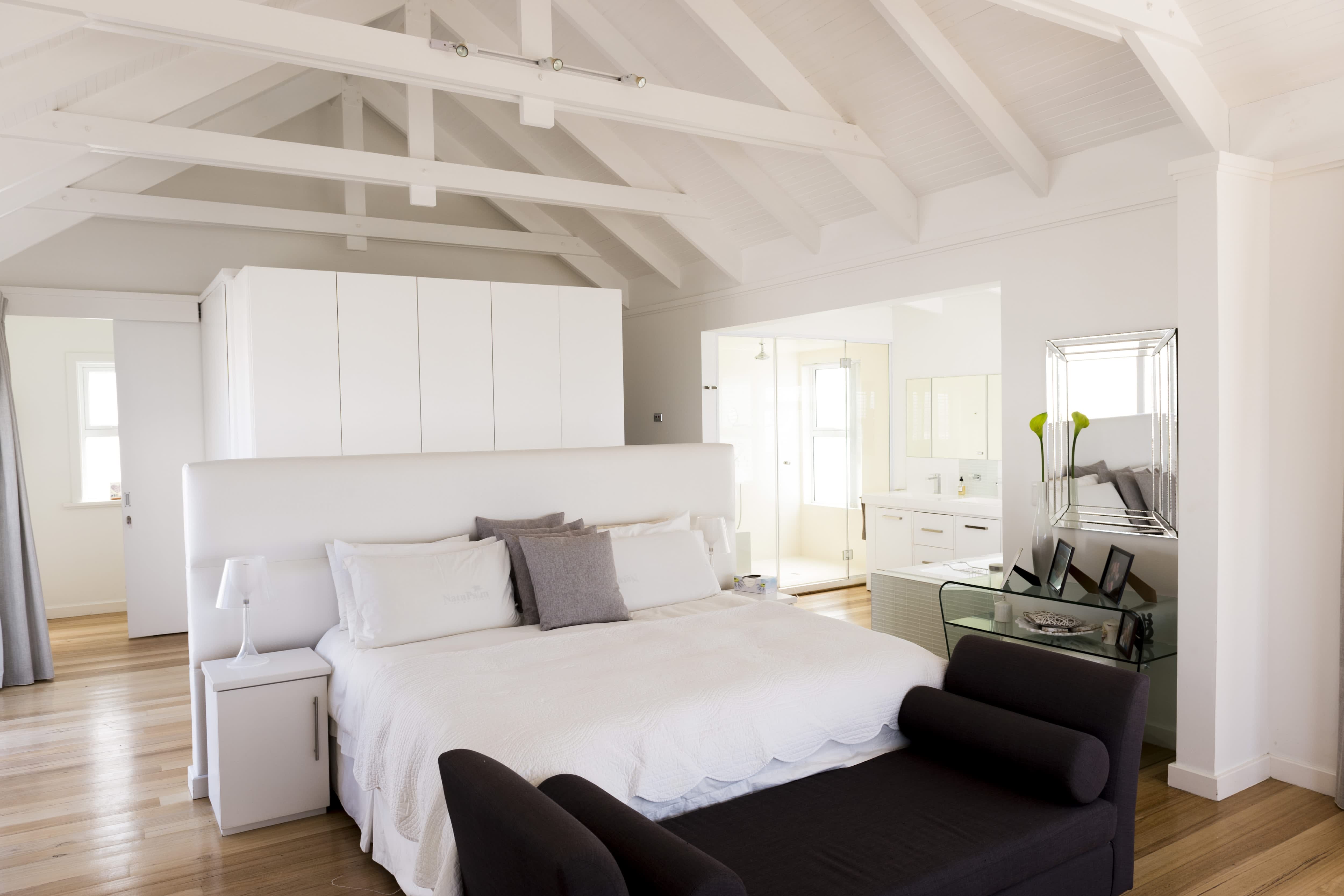 All white sleeping area in studio apartment