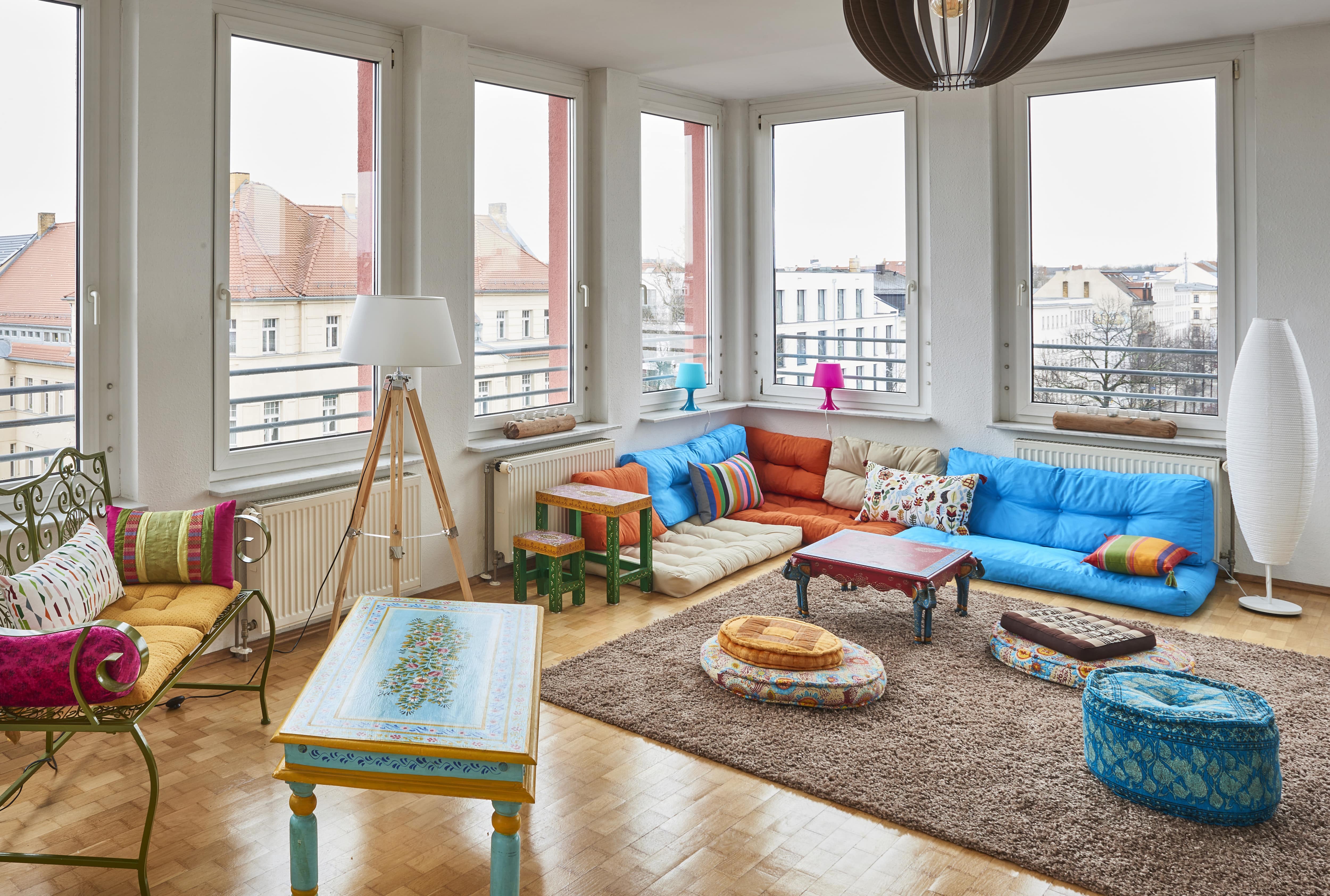 Bohemian floor pillows in studio apartment