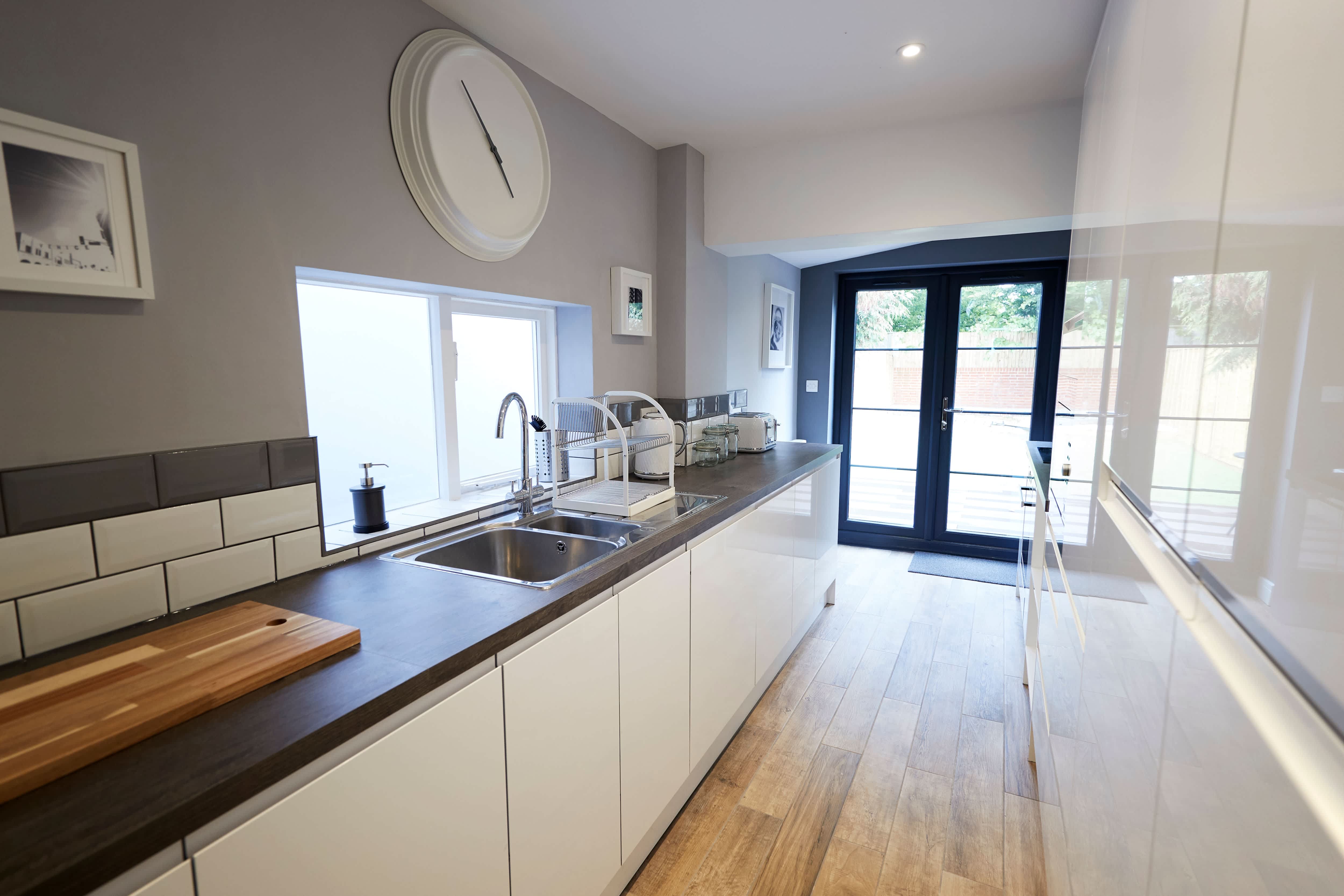 A small galley kitchen with all-white cabinets
