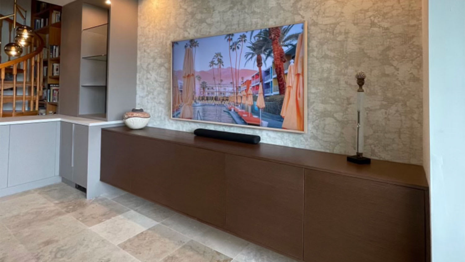 A living room with wood console and tile floor