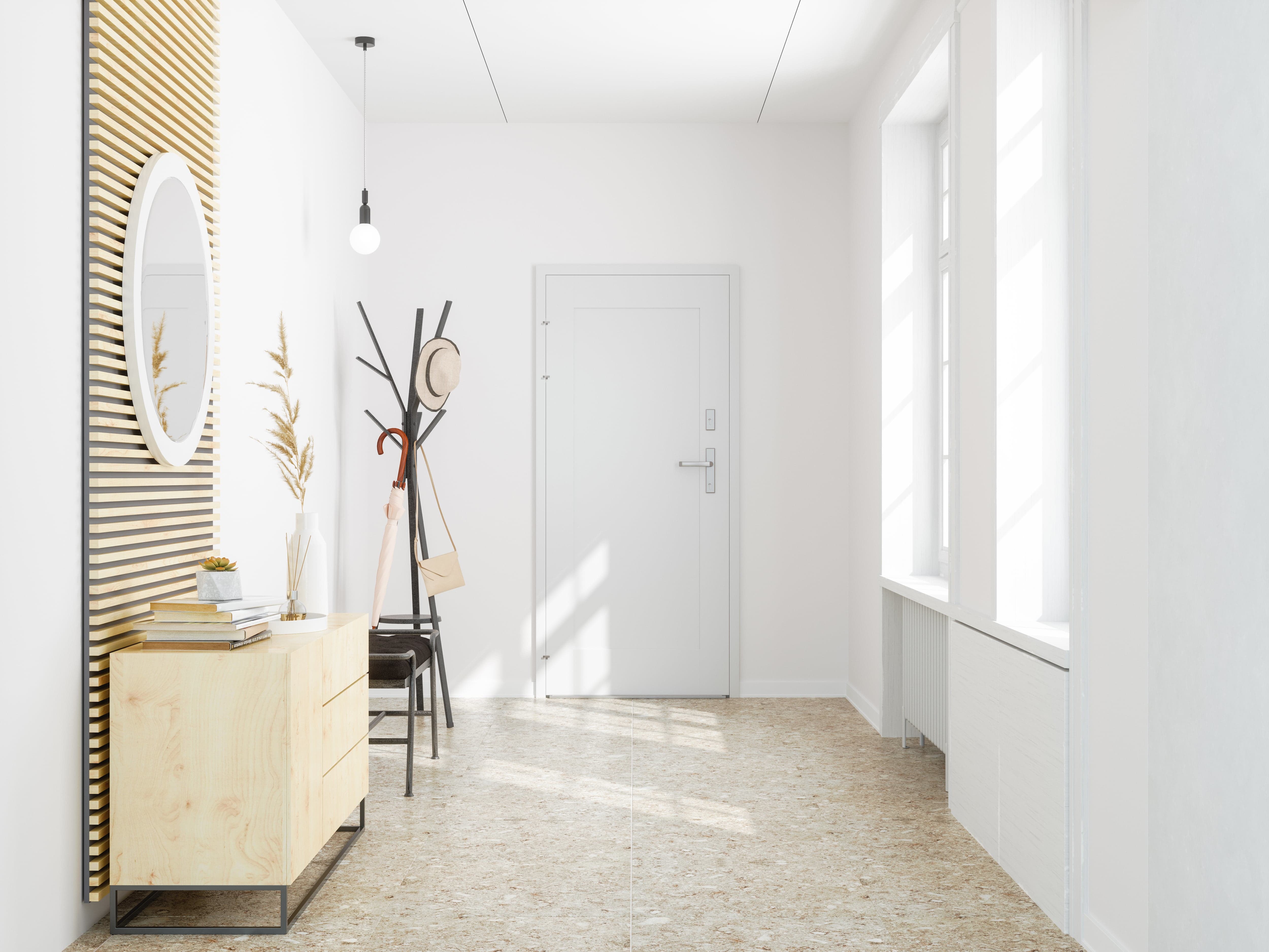 A home entryway with white walls and a partial wood accent wall