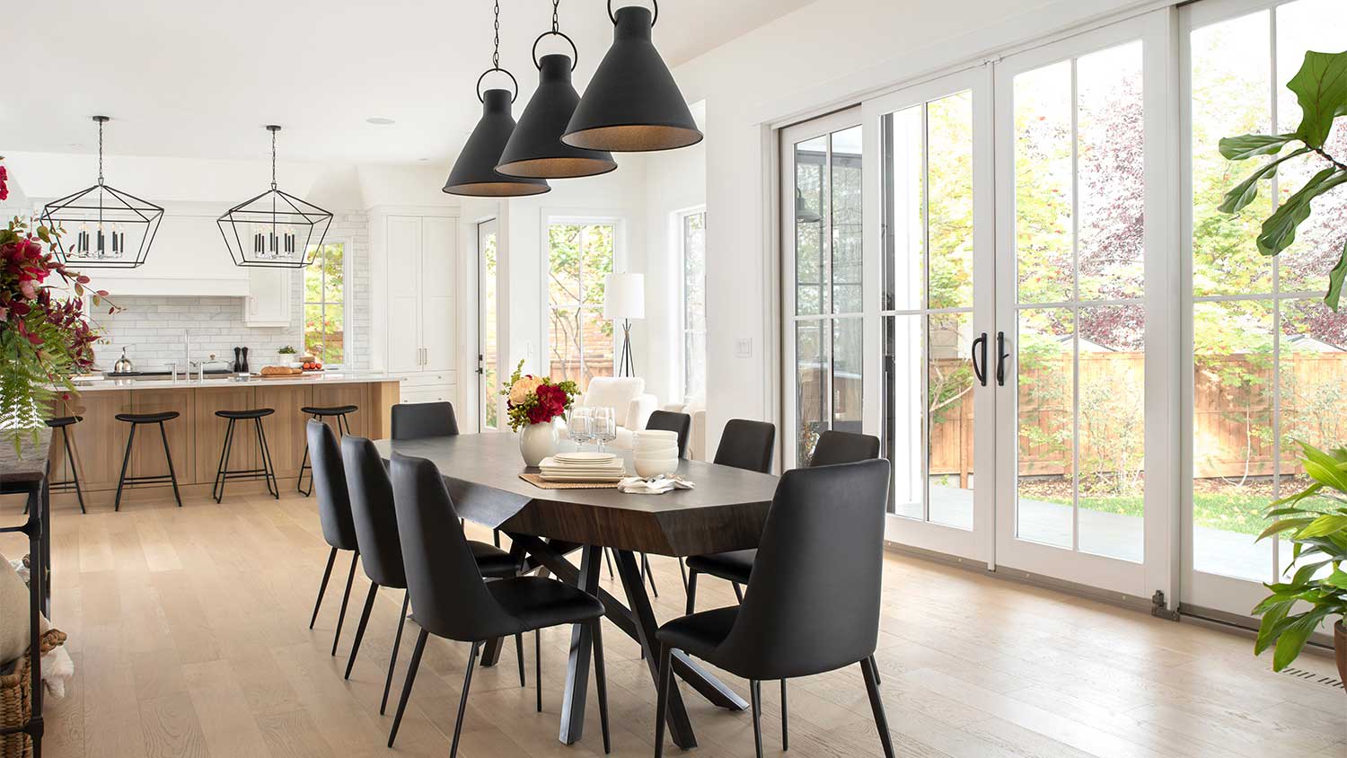 Black pendant lights and dining table