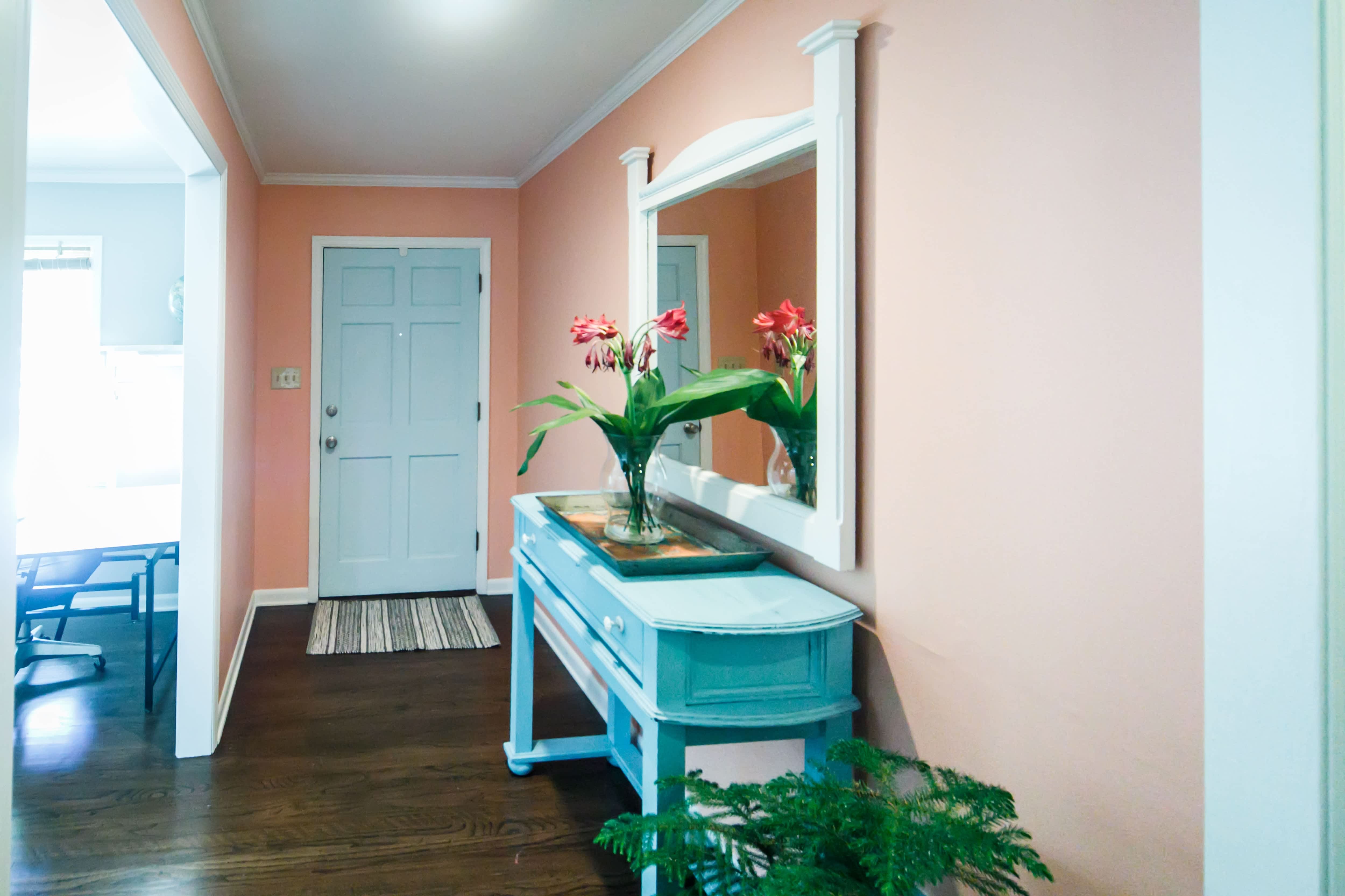 A bright and colorful peach and turquoise home foyer