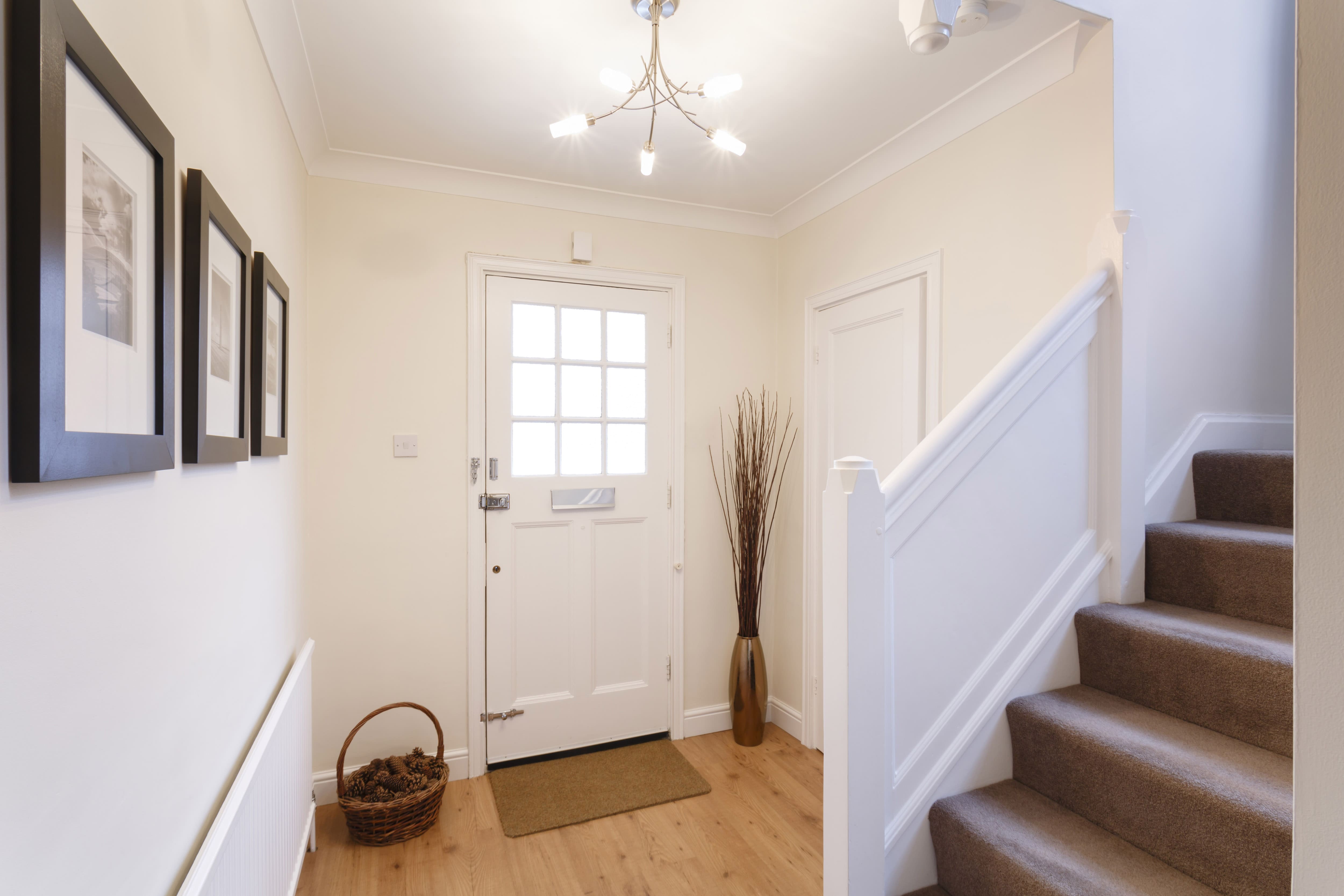 A small, simple entryway with a decorative photo wall