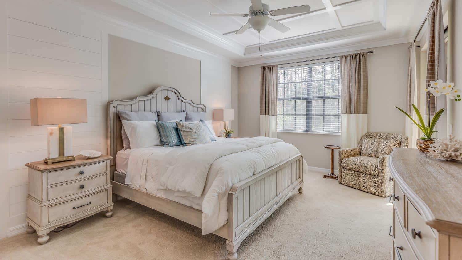 A carpeted bedroom painted in light tones